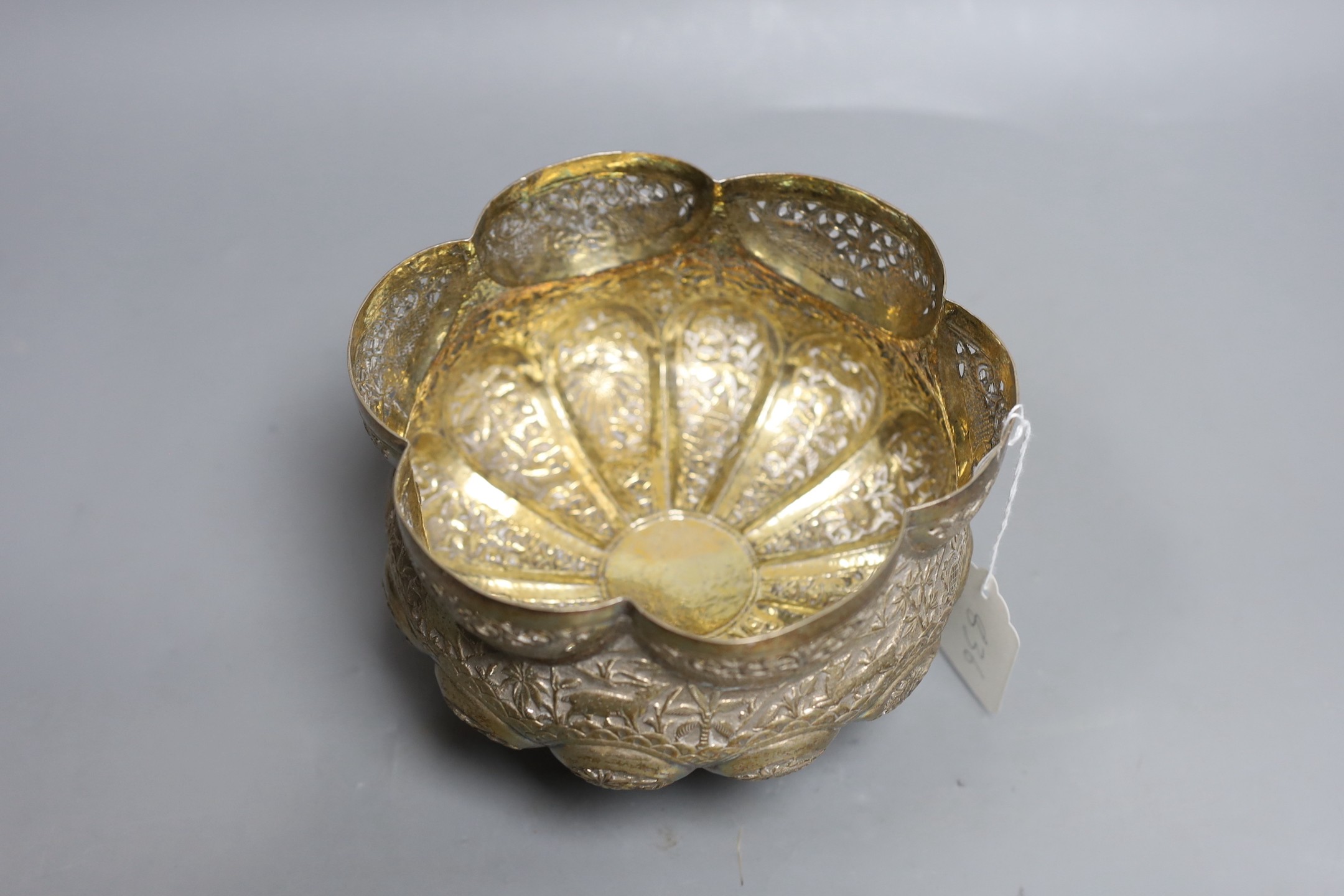 An Indian embossed white metal bowl, on three entwined serpent feet, diameter 17.5cm, 13.9oz.